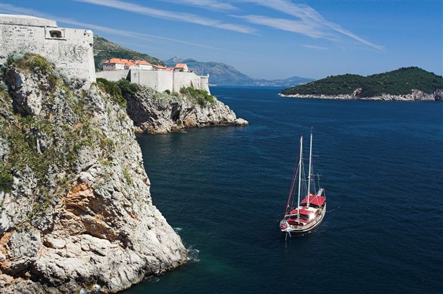 Motor-Sailer at anchor below the cliffs