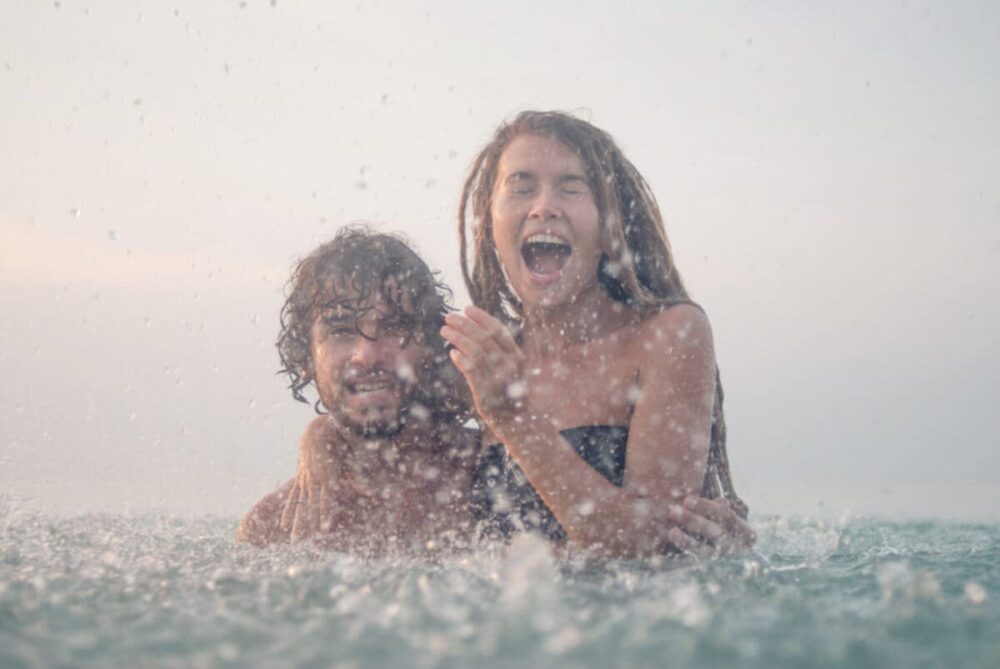 Couple in the rain while in a yacht charter activity