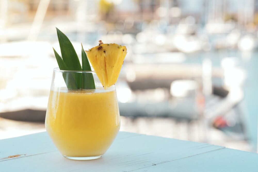 catamaran charter tropical drink with pineapple garnish