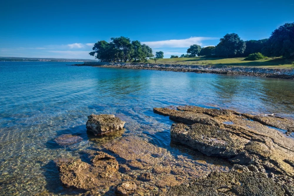 Clear blue water and sky with Veli Brijun Island in background