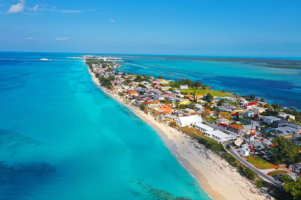 aerial view of several beach houses on a small peninsula