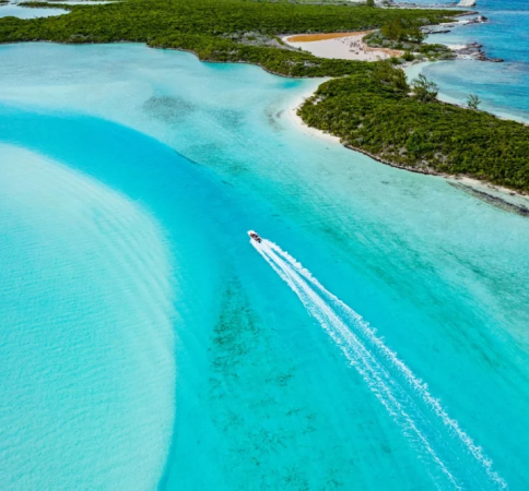 aerial view of a speedboat near a tropical beach on a luxury yacht charter.