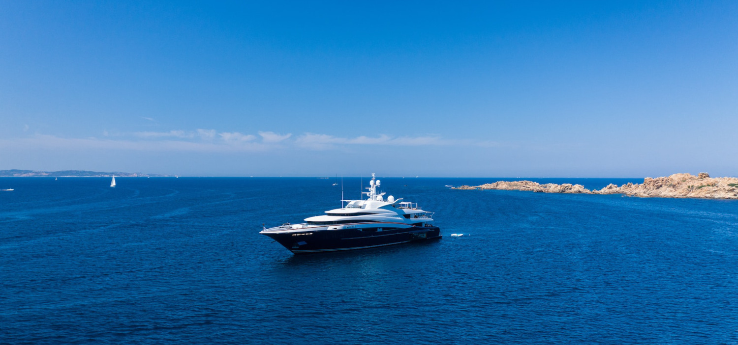 luxury yacht off the coast of an island