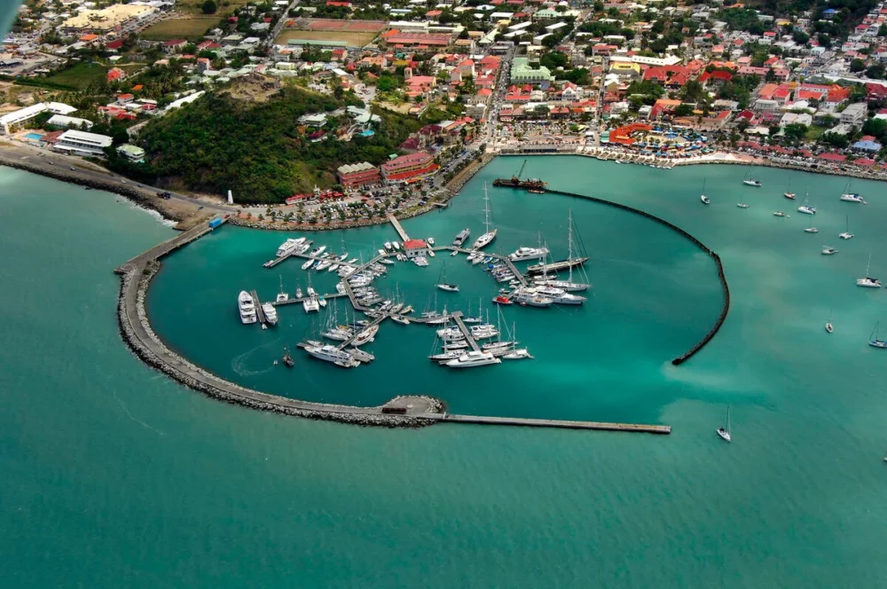 Aerial view of Fort Louis Marina in Marigot, Saint Martin, with docked sailboats and motorboats.


