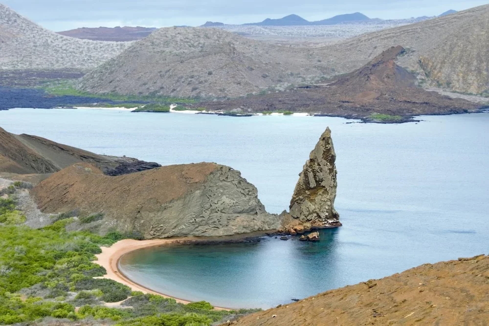 A scenic view of Galápagos Island with its rugged coastline, clear waters, and diverse wildlife, perfect for a private cruise charter.