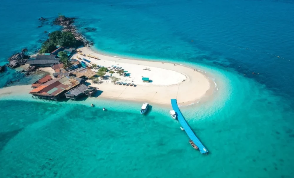 Aerial view of Kho Khai Nai Island in Phuket, Thailand. A small island with white sand beaches and clear turquoise water, a unique destination for your next private sailing charter.

