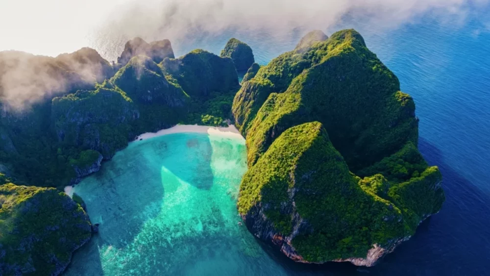 Aerial view of Phi Phi Island's emerald green cliffs and turquoise lagoon.