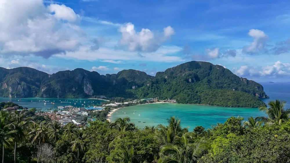 A breathtaking view of Phi Phi Island in Thailand, featuring lush green mountains and turquoise waters, 