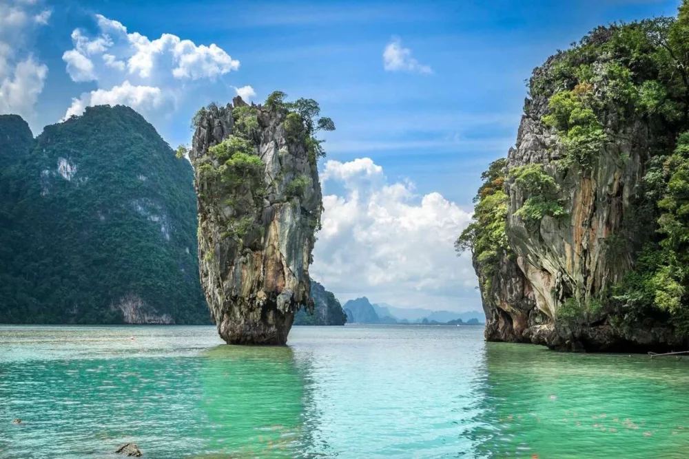 Phuket, Thailand beach with clear waters and lush greenery, ideal for private crewed yacht charters in Southeast Asia.

