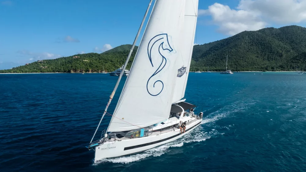 Luxury sailing yacht, the SERENA Yacht, a private sailing charter cruising on clear blue water.