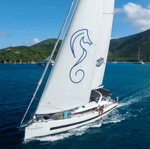 Luxury sailing yacht, the SERENA Yacht, a private sailing charter cruising on clear blue water.