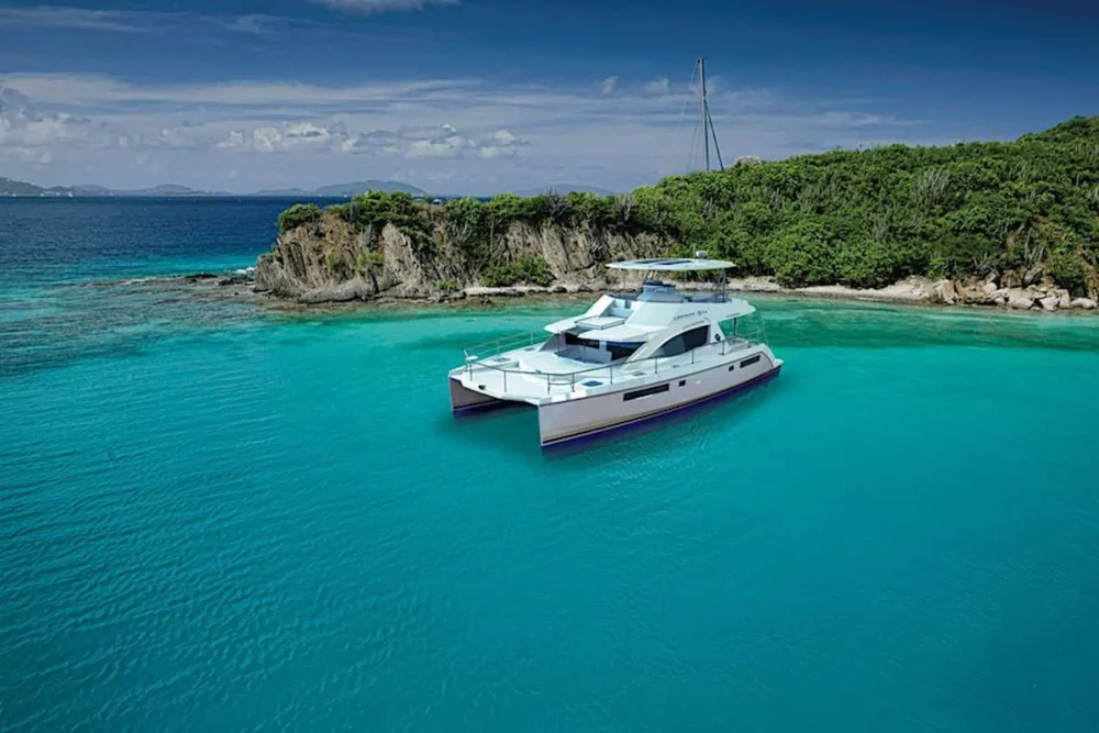 Somewhere Hot, a luxurious power catamaran, is docked in the waters of British Virgin Islands, a perfect crewed yacht vacation.