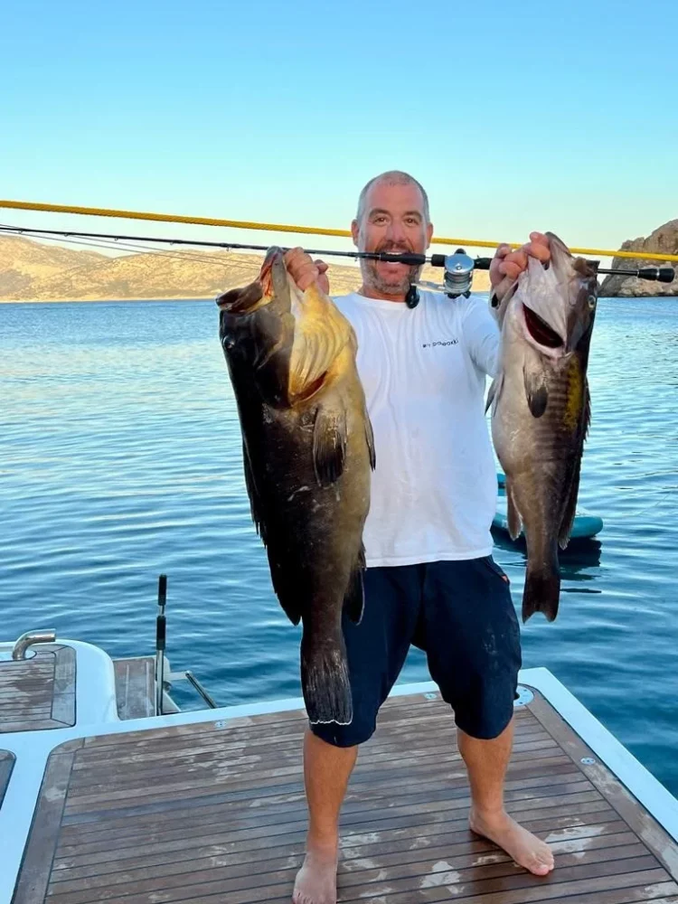 Captain Panos with two freshly caught fish in Greece