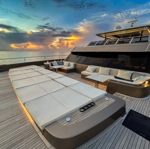 Nauti Nickel, a luxury catamaran with plush seating and a sunbathing area on the deck.